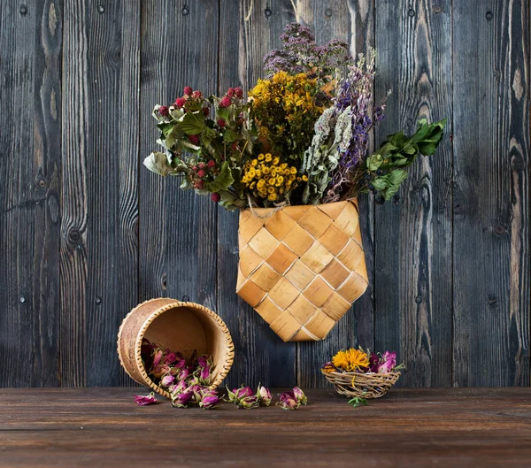Healing herbs and flowers on a wooden background. Herbal medicine concept