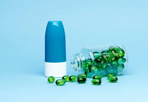 Medical capsules pills and bottle for medicine on a blue background