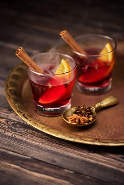 Hot wine mulled wine with spices in glasses on a wooden table. Winter hot drink