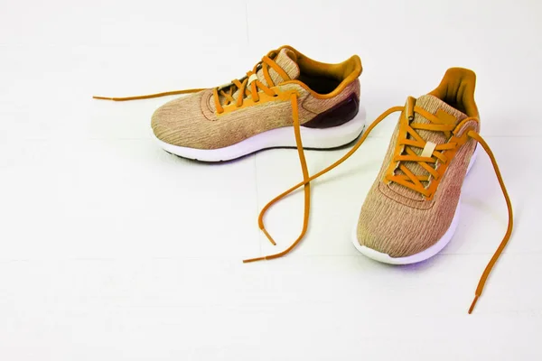 Beautiful women's sports sneakers with untied laces