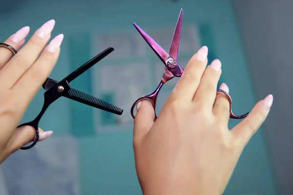 Two scissors, opening and closed thinning shears for Hairdresser\'s salon