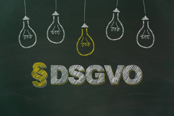 DSGVO in german chalk writing meaning GDPR with yellow and white light bulbs painted on dirty green chalkboard