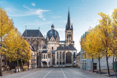 Aachen Almanya Katschhof sarı ağaçlara karşı arka planda mavi gökyüzü ile sonbahar sırasında büyük Gotik Katedrali