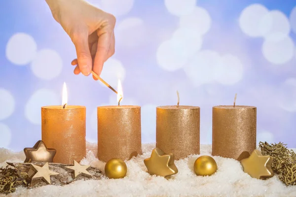 Τέσσερα Χρυσά Κεριά Δύο Κεριά Αναμμένα Χέρι Αγώνα Και Χριστουγεννιάτικη — Φωτογραφία Αρχείου