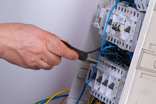 electrician fixing  electrical devices with different tools