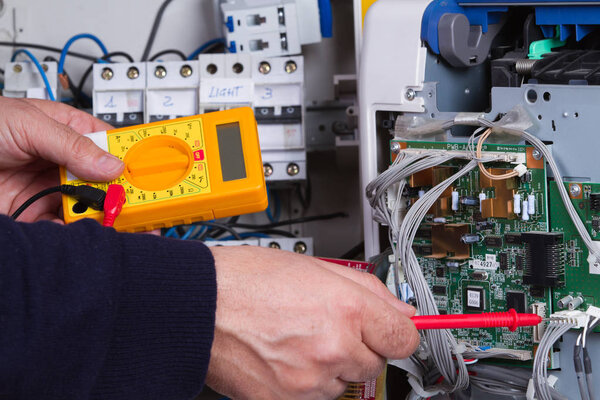 electrician fixing electrical device
