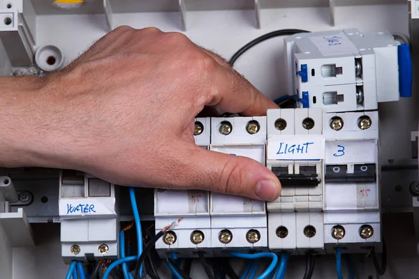 electrician fixing electrical device