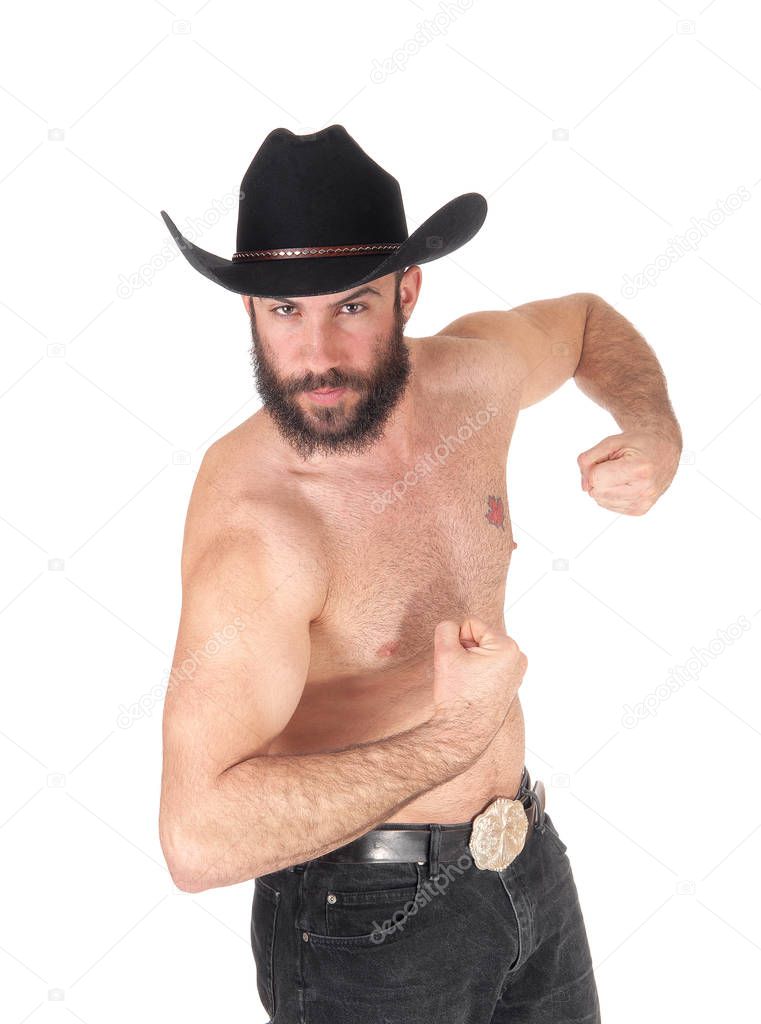 Young man standing shirtless, wearing a black cowboy hat and blac