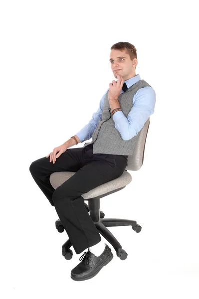 Man sitting in dress pants and vest, thinking — Stock Photo, Image