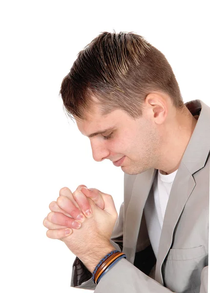 Young man praying with hands folded — Stock Photo, Image