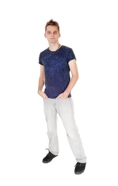 Puzzled young man standing with hand in his pocket — Stock Photo, Image