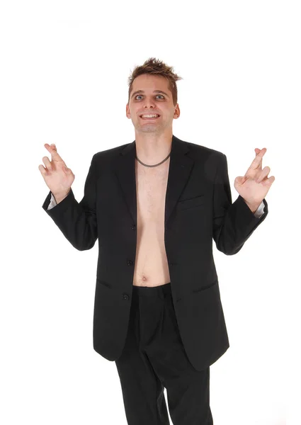 Man with out shirt and jacket standing with fingers crossed — Stock Photo, Image