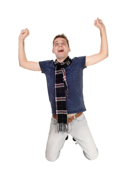 Man on his knees lifting up his fists — Stock Photo, Image