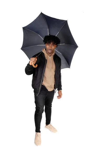 Black man standing in the studio with umbrella — Stock Photo, Image