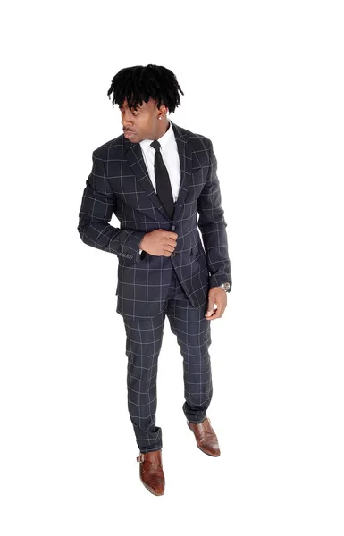 Relaxed black man standing in a dank suit looking away — Stock Photo, Image
