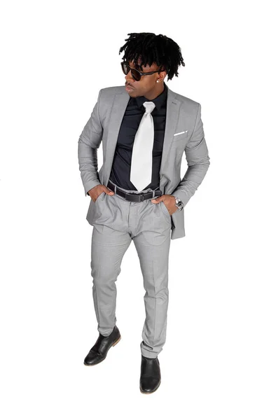 A black young man standing in a gray suit and sunglasses — Stock Photo, Image