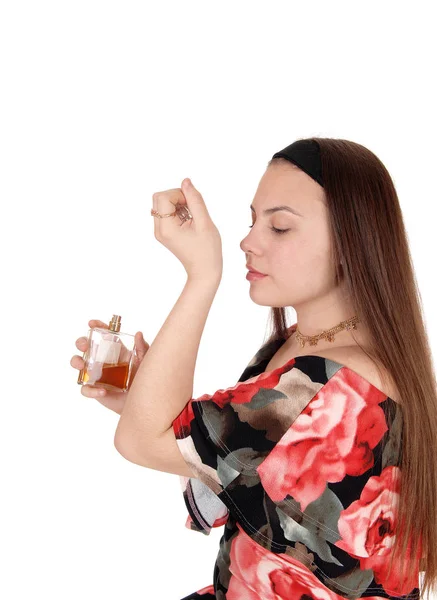 Teenager girl smelling the perfume on her wrist — Stock Photo, Image