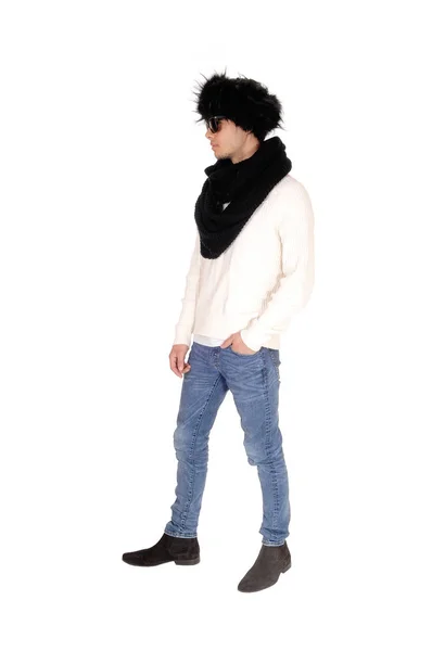 Tall young man standing in profile with fur hat — Stock Photo, Image
