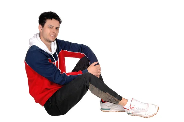 Jovem feliz sentado no chão descansando do exercício — Fotografia de Stock