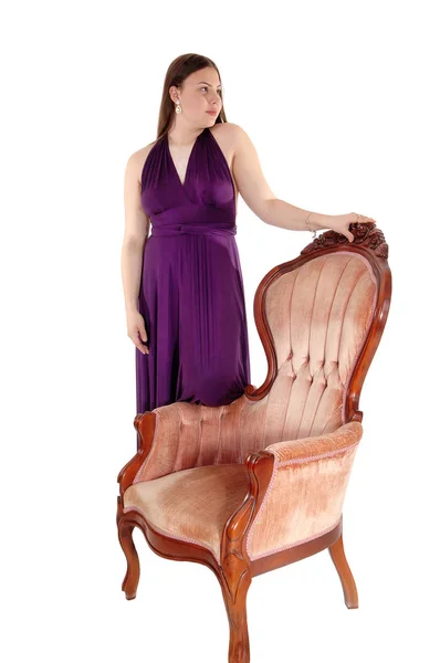 Teenager girl standing in her prom dress on armchair — Stock Photo, Image