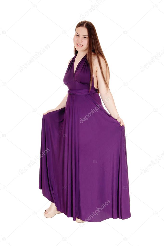 Teenager girl standing in her burgundy prom dress