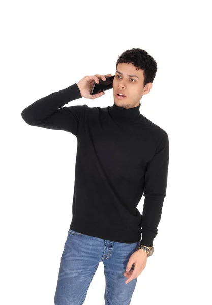 Tall handsome man talking on the cell phone, surprised — Stock Photo, Image