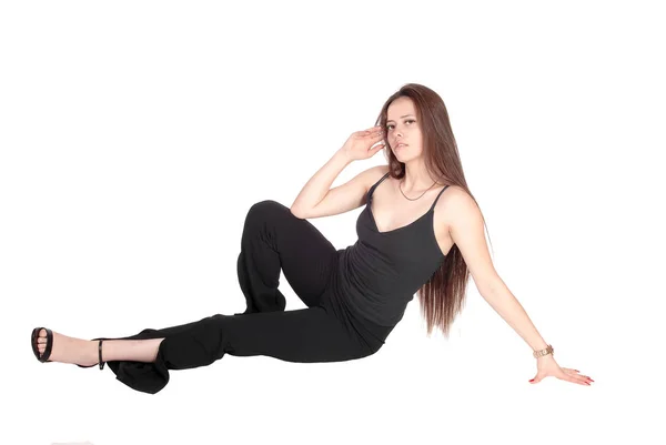 Lovely young woman sitting on the floor in the studio — Stock Photo, Image