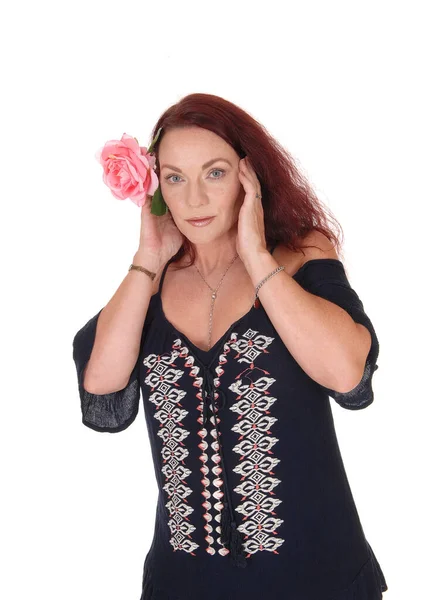 Beautiful woman with red hair and a pink rose — Stock Photo, Image