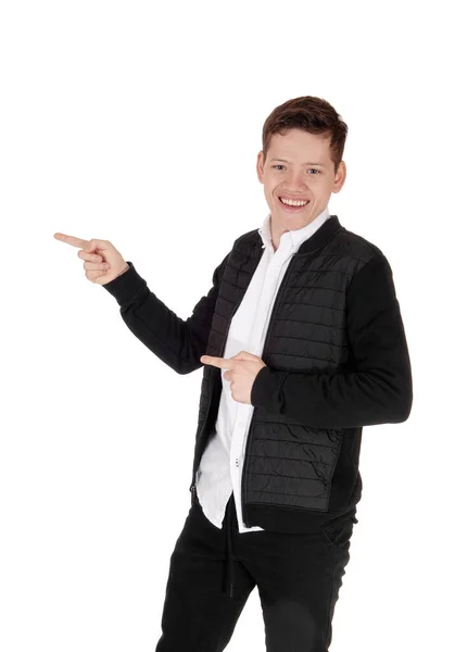 Smiling young teen boy standing, pointing with his fingers — Stock Photo, Image