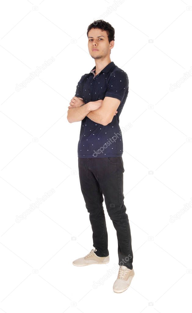 Tall young man standing with his arms crossed