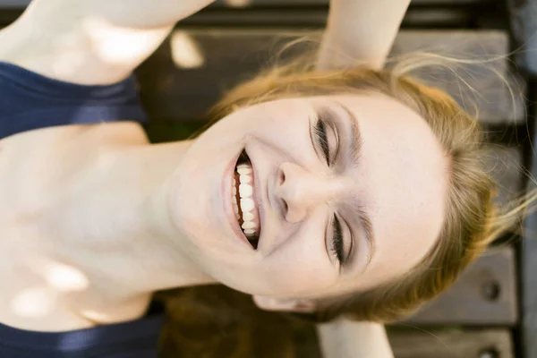 Happy Young Woman Lying on a Bench — Stock Photo, Image