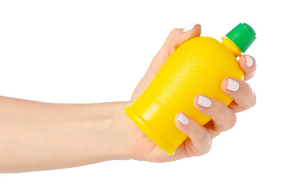 Yellow bottle with lemon juice in hand — Stock Photo, Image