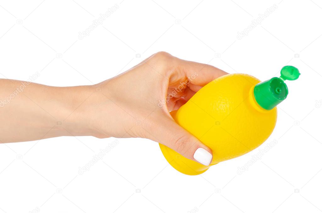 Yellow bottle with lemon juice in hand