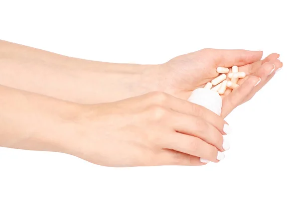 Tarro blanco de pastillas en la mano — Foto de Stock