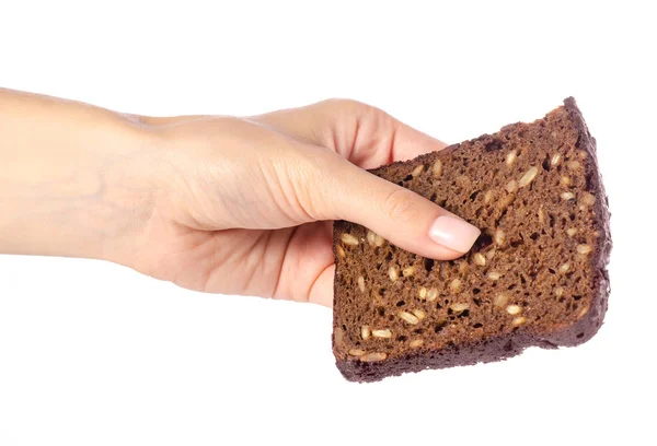 Ein Stück Brot mit Samen in der Hand — Stockfoto