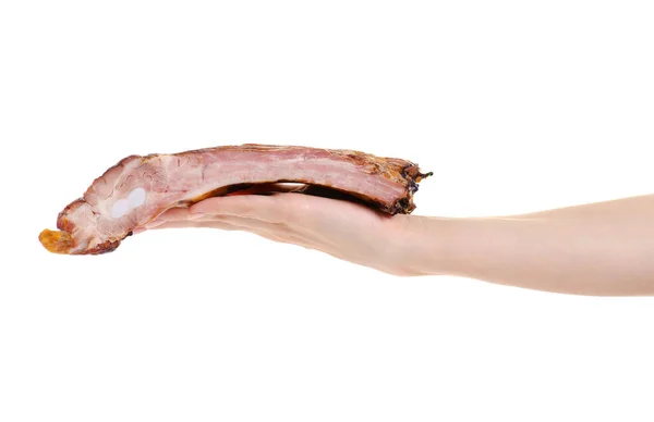 Свиные копченые ребрышки в руке — стоковое фото