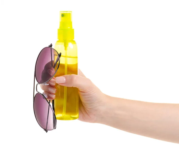 Bottle spray for suntan sun glasses in hand — Stock Photo, Image