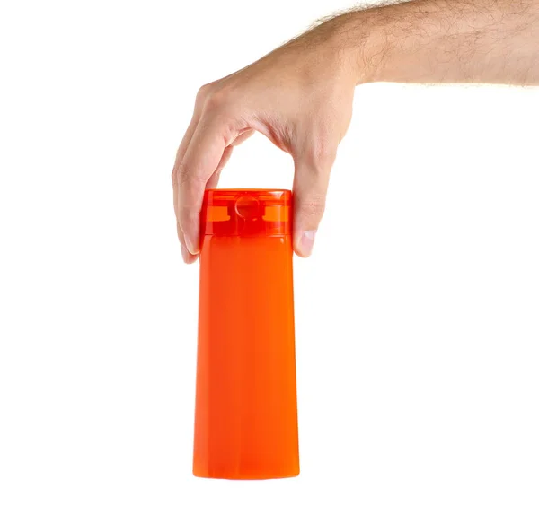 Orange bottle beauty shampoo shower gel in hand — Stock Photo, Image