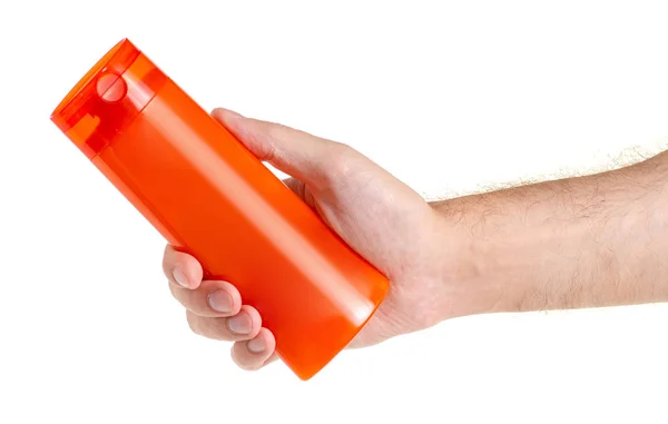 Piękno pomarańczowy butelka szampon żel pod prysznic w ręku — Zdjęcie stockowe