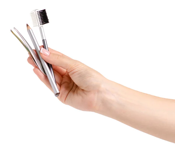 Brush for eyebrow pencil tweezers in hands — Stock Photo, Image