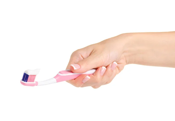 Toothbrush with paste in hand — Stock Photo, Image