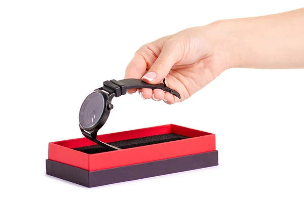 Die schwarze Uhr in einer Box in der Hand — Stockfoto