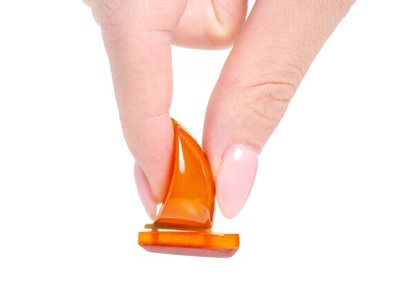 Amber stone brooch in hand