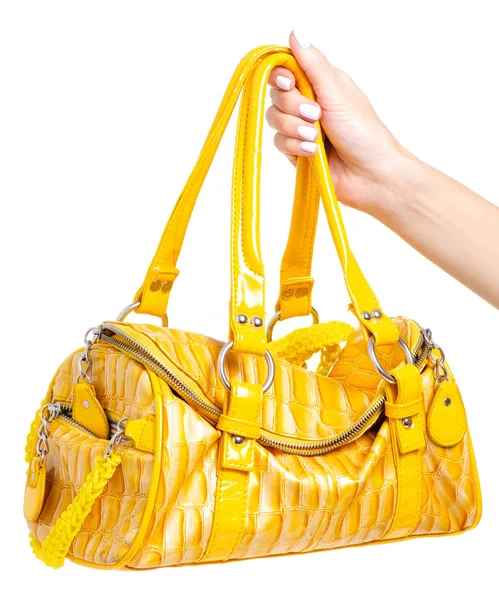 Női sárga bőr táska a kezében — Stock Fotó