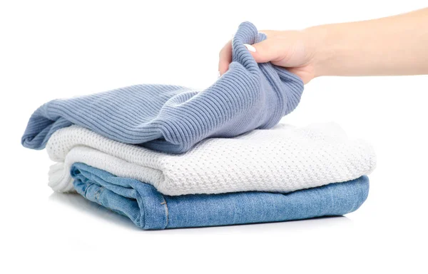 Pila de ropa jeans suéteres en la mano — Foto de Stock