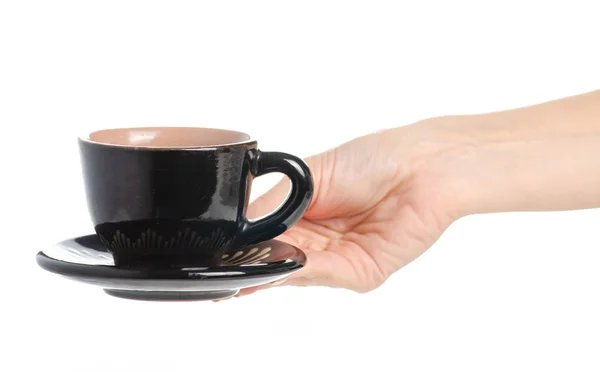 Schwarze Kaffeetasse und Untertasse in der Hand — Stockfoto