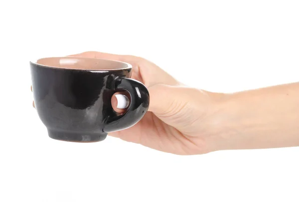 Zwart koffiekopje in de hand — Stockfoto