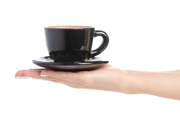 Μαύρο φλιτζάνι καφέ και πιατάκι στο χέρι — Φωτογραφία Αρχείου