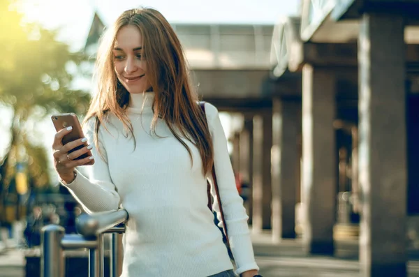 Camisola jovem mulher na mão smartphone telefone celular falando no telefone — Fotografia de Stock