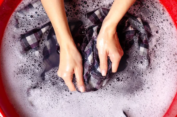 Women washing color clothes shirt in basin enemale powdered detergent — Stock Photo, Image